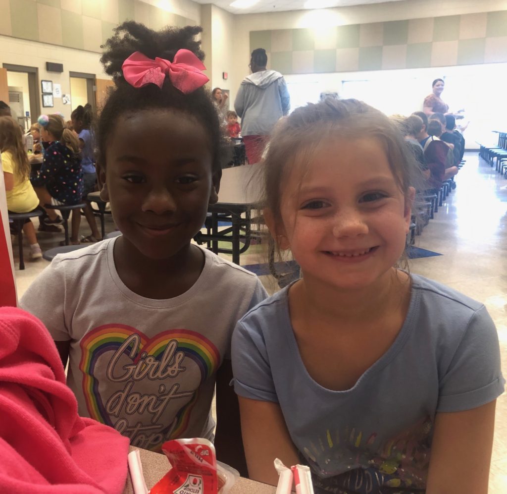 Two little friends enjoying lunch together.