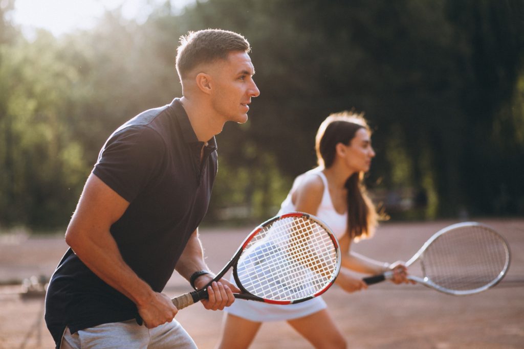 Couple playing tennis together is a great way to help stay active and provide a little competition. 