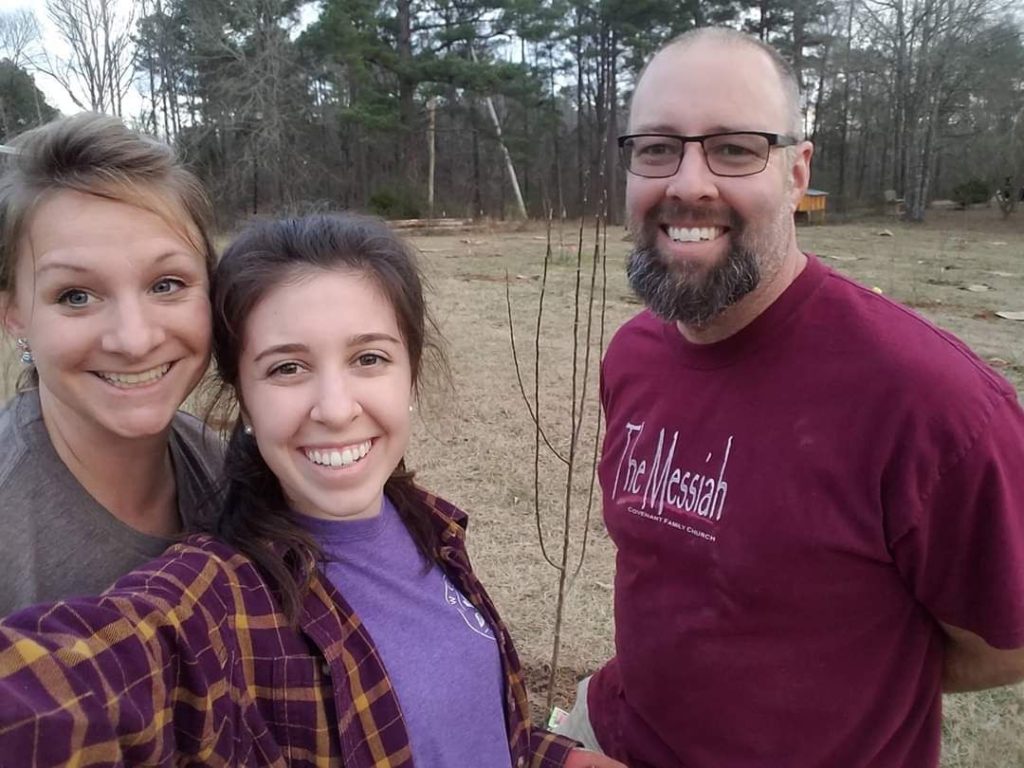 Family outside on a fall day. It is a selfie of two women and a man. The women are stepmother and stepdaughter. All are smiling and happy. The purpose of the picture is to show the happy relationship between a stepchild and stepmom on Mother's Day.