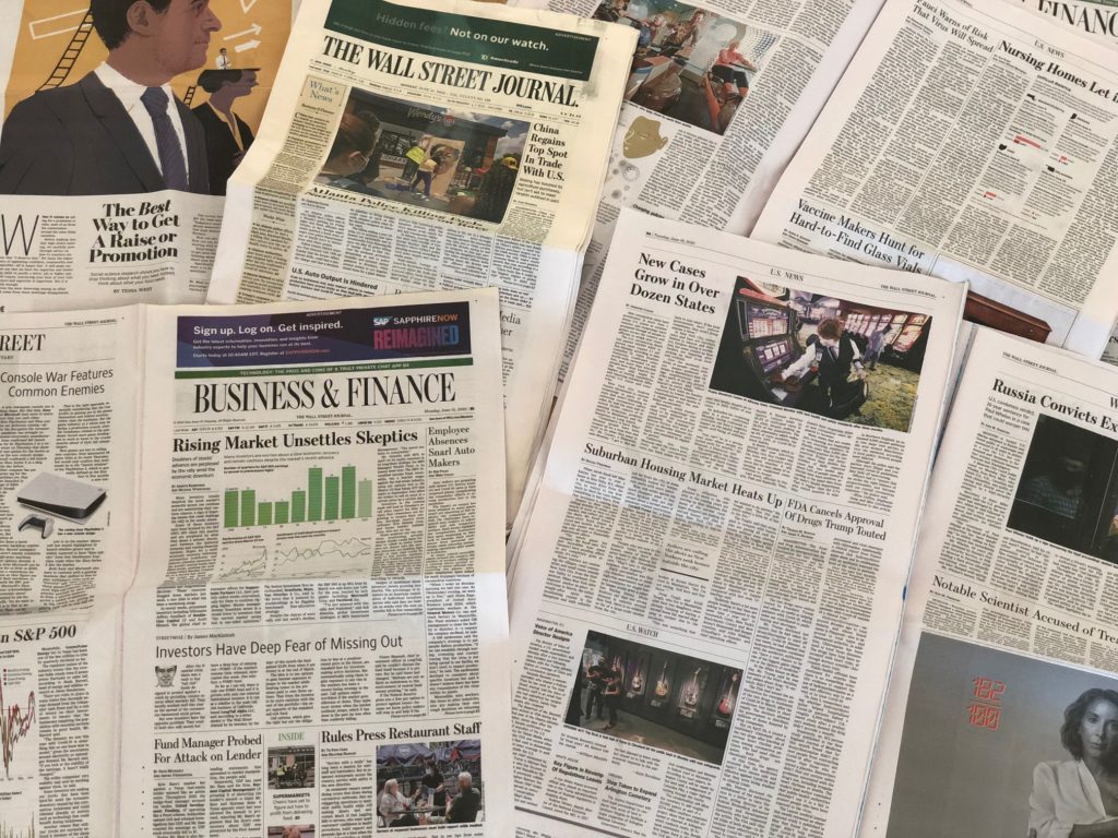 A picture of news papers overlapping each other. 