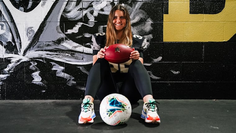 Sarah Fuller sitting down with soccer ball between her feet and holding football in her hands.
