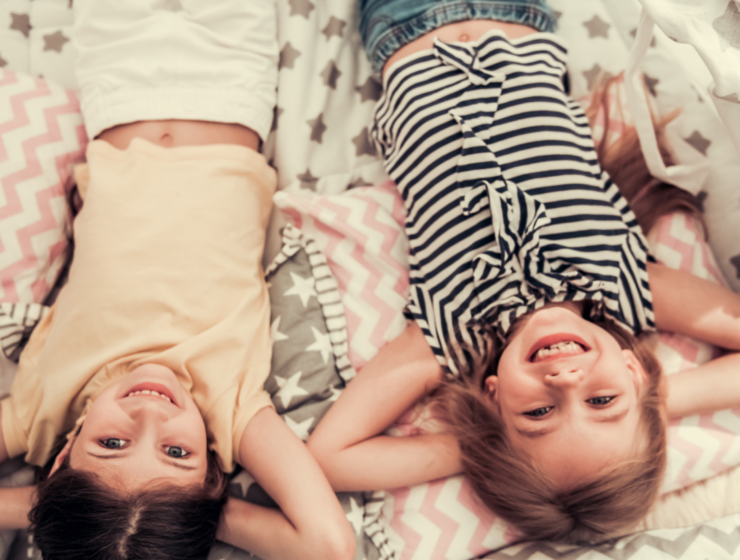 two little girls laying on their back